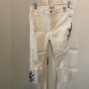 White cropped jeans, 6 short. Blue flowered embroidery on R thigh, L shin.